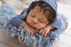 a baby is sleeping in a blue blanket