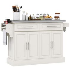 a white kitchen island with lots of food on it