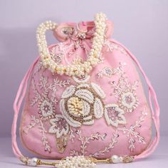 Material:Silk, Golden Tread, Golden Sequins, MotifsColor: Pink, Orange, Yellow, BluePackage Contents: As per quantity purchasedDesigned with the heart, this beautiful Potli or batawa bag are eye catchy and made of premium material.Key Features:Embroidery art work.This potli is good match with both Indian and western outfits and are superb for wedding and festive parties.This would be best complement to your designer saree, lenhga or any other kind of dress.This is the combination of traditional Traditional Pink Shoulder Bag For Evening, Pink Bags For Evening And Festivals, Festive Embroidered Clutch Evening Bag, Pink Shoulder Bag With Handwork For Party, Embellished Potli Bag For Gift, Festive Embellished Potli Bag As Gift, Beaded Festival Clutch Bag, Festival Beaded Clutch Bag, Pink Floral Embroidered Clutch Bag