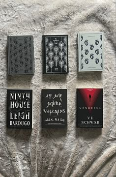 four books are laid out on a blanket