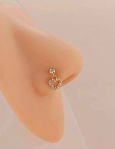 an earring with two hearts on top of it, in front of a white background