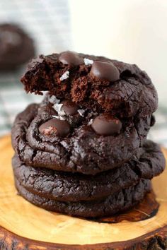 chocolate cookies stacked on top of each other with one bite taken out of the cookie