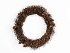 a wreath made out of twigs and pineconis on a white background with copy space