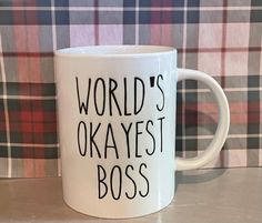 a white coffee mug that says world's okayest boss