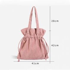 the measurements of a pink handbag with draws on one side and an attached shoulder strap