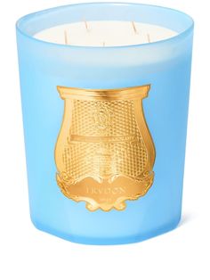 a blue candle with gold trim on it