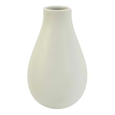 a white vase sitting on top of a table