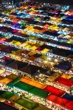 an aerial view of many colorful umbrellas at night