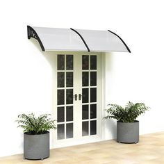 two planters with plants in front of a white door