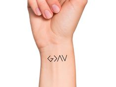 God is Greater Temporary Tattoo Size: The size of this temporary tattoo is approximately 1 1/2 inches Directions: 1. Cut excess paper around tattoo with scissors to eliminate any unnecessary adhesive on your skin after applying. 2. Peel away the clear plastic layer. 3. Apply the tattoo image side to your skin and cover with a damp cloth for 20 seconds. 4. Carefully peel back paper off of your skin and allow the tattoo to dry for at least 10 seconds. Do not touch it. 5. After allowing for dry tim God Is Greater Than The Highs And Lows Shirt, High And Lows Tattoo, Highs And Lows Tattoo, Delicate Tattoos For Women, Delicate Tattoo, Cross Art, Wrist Tattoo, Dainty Tattoos, Time Tattoos