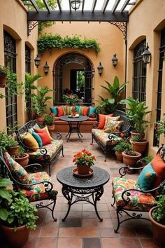 an outdoor patio with lots of plants and furniture