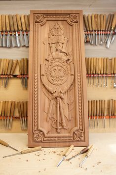 the carving is being worked on in this woodworking project, with tools and other items