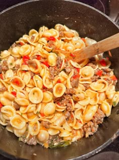 a skillet filled with pasta and meat