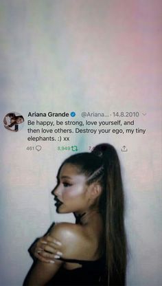 an image of a woman with long hair on her face and the caption aria grande