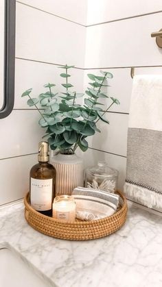 a bathroom sink with soap, lotion and candles on it