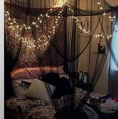 a bed with some lights hanging from it's headboard