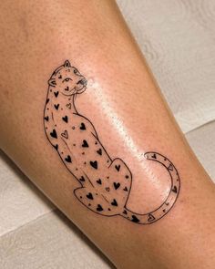 a tattoo on the leg of a woman with a cheetah in black ink