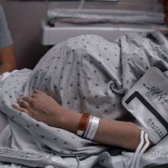 a person laying in a hospital bed with an iv