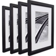 three black and white framed pictures hanging on the wall next to each other with an image of a bridge in it