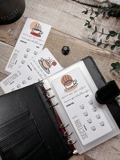 an open planner book sitting on top of a wooden table