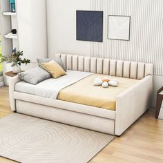 a white bed sitting on top of a wooden floor