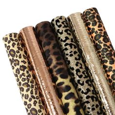 five different types of animal print fabric in various colors and sizes, all lined up together