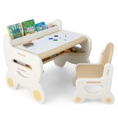 a child's desk and chair with books on it, set against a white background