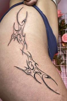 a woman's thigh with a tattoo design on the lower part of her leg