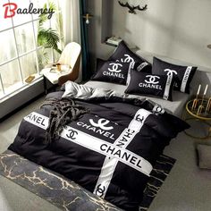 black and white bedding with chanel logo on it in a bedroom area next to a window