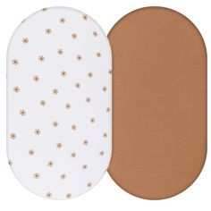 two oval pads with flowers on them, one in white and the other in brown