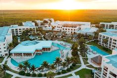 an aerial view of the resort and pool at sunset