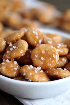 a white bowl filled with sugar covered donuts