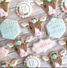 decorated cookies are arranged on a wooden table