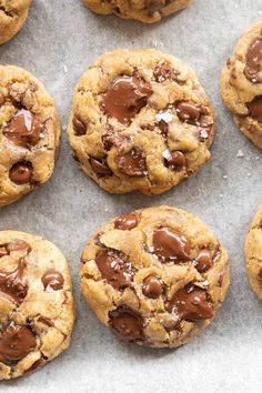 chocolate chip cookies on a baking sheet lined with parchment paper, ready to be eaten