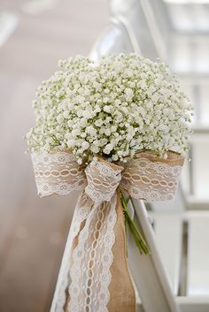 a bouquet of baby's breath tied to a chair