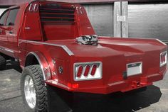 a red pick up truck parked in front of a building