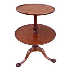 two tiered wooden table with wheels on the top and one shelf holding an object