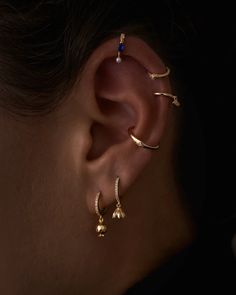 a woman's ear is shown with three different types of piercings