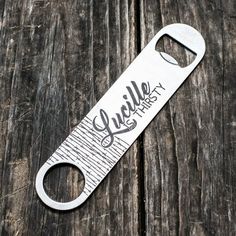 a bottle opener sitting on top of a wooden table