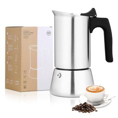 a stainless steel coffee maker next to a box of coffee beans and a cup of cappuccino