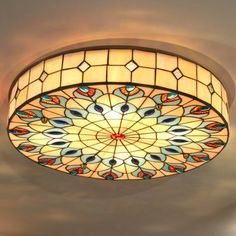 a stained glass ceiling light hanging from the ceiling