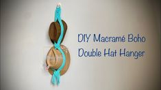 a hat hanging on a wall with the words diy macrame boho double hat hanger