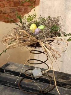 an arrangement of twigs and eggs in a vase