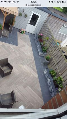 an aerial view of a backyard with patio furniture