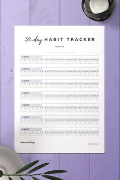 a printable 30 day habit tracker is displayed on a purple background next to a cup of coffee