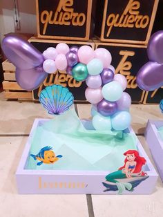 the little mermaid balloon arch is set up in front of some other balloons and decorations