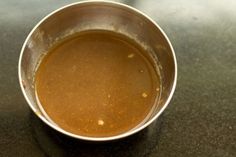 a metal cup filled with liquid on top of a table