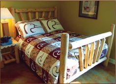 a wooden bed with two pillows on it and a night stand next to the bed