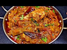 a pan filled with meat and vegetables covered in sauce