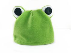 a green frog hat with eyes on it